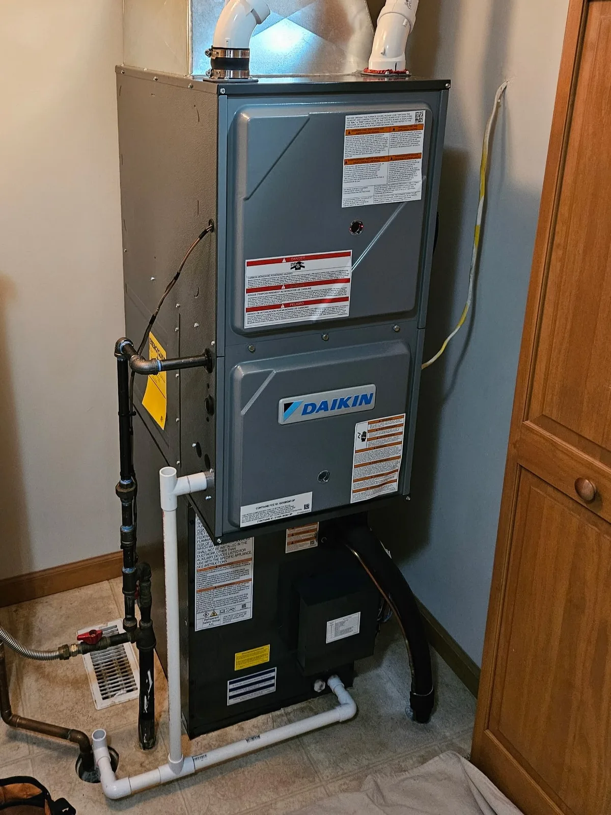 Dixon's installed Daikin high-efficiency gas furnace with branded logo visible